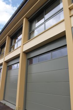 two garage doors are open in front of a house