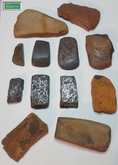 several different types of rocks on a white surface