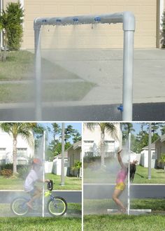 a man riding a bike next to a water sprinkler