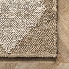 a white rug on top of a wooden floor