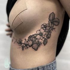 a woman's stomach with flowers and leaves on it