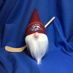 a red and white gnome's hat on top of a wooden sled