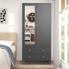 a bedroom scene with focus on the armoire and bed