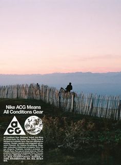 a man riding on the back of a horse next to a tall wooden barb wire fence