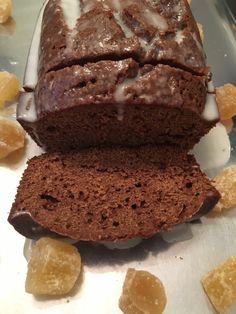 there is a loaf of bread with icing on it next to some sugar cubes