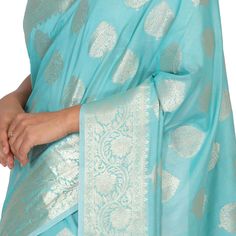 If you're looking for a saree that exudes elegance and refinement, look no further than the Monica Silk Banarasi saree. This beautiful piece is crafted from traditional banarasi silk, and features a stunning silver border. The blouse is stitched and ready to wear, making this saree a perfect option for any special occasion. Whether you're attending a wedding or a formal event, the Monica Silk Banarasi saree is sure to make you look and feel your best. Fall and Pico - Done Blouse - Stitched Silk Banarasi Saree, Banarasi Saree, Banarasi Sarees, Alexander Mcqueen Scarf, Formal Event, Sky Blue, A Wedding, Blue Sky, Kimono Top