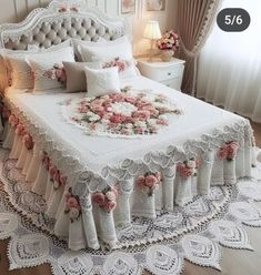 a white bed with pink roses on it