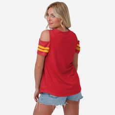 Someone doubting your fandom? Give 'em the cold shoulder by rocking this Kansas City Chiefs Women's Cold Shoulder T-Shirt. Features All-over team-colored design so you can rep the team in style Bold team logo display on front, in case there were any doubts where your allegiances lie Chic cutout tops at the shoulders that will take your look to the next level V-neck collar where the "V" stands for "VERY COOL" Team-colored stripe accents on sleeve cuffs to add a little fan flair to your outfit Sho Cutout Tops, Outfit Short, Viking Woman, Logo Display, Cut Out Top, Minnesota Vikings, Kansas City Chiefs, Bold Fashion, Neck Collar