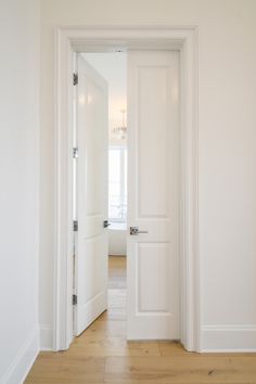 an open door leading into a white room