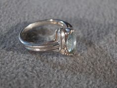 This gorgeous ring is a vintage piece that will enhance your wardrobe for the upcoming fashion season. It has the following characteristics: * individually set marquise shaped blue topaz stone * sterling silver setting and band * fabulous decorative styling on the band and setting * size 7 Lots of sparkle and glitz with this piece. You will love to own it! Buyer pays all shipping and handling costs. Formal Turquoise Ring With Accent Stones, Vintage Turquoise Gemstone Ring For Formal Occasions, Vintage Turquoise Ring For Formal Occasions, Vintage Topaz Ring With Accent Stones, Vintage Topaz Promise Ring With Accent Stones, Vintage Marquise Cut Rings With Accent Stones, Vintage Blue Topaz Ring With Prong Setting, Vintage Marquise Cut Ring With Accent Stones, Vintage Oval Blue Topaz Rings