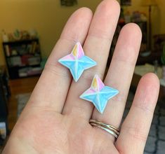 two star shaped rings sitting on top of someone's hand