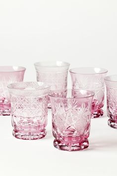 a set of pink glass cups sitting on top of each other