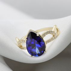 A Sapphire ring ring rich with presence and diamonds. Flaunting a beautiful pear cut Sapphire corundum prong set in your choice of solid gold. Handmade by an inspired jewelry artist team with decades of experience in the craft of jewelry making. Each gemstone, each diamond is carefully picked. Using only the finest raw materials and the highest industry standard in manufacturing, design and finish. A beautiful vintage inspired piece handmade just for you. Set with a 12x8 pear cut blue sapphire c Teardrop Diamond Ring With Accent Stones, Teardrop Gemstone Ring For Formal Occasions, Pear-shaped Sapphire Diamond Ring, Yellow Gold Teardrop Sapphire Ring Fine Jewelry, Teardrop Yellow Gold Sapphire Ring, Elegant Gold Ring With Lab-created Sapphire, Teardrop Sapphire Ring In Yellow Gold, Pear-shaped Sapphire Ring With Diamond Accents, Fine Jewelry Pear-shaped Diamond Ring With Accent Stones