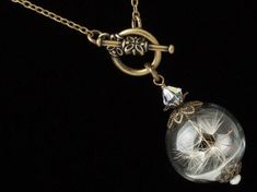 "Wish Necklace, Dandelion Necklace made with a Hand Blown Glass Orb filled with Real Dandelion Seeds accented by Genuine Pearl, Swarovski Crystal and Brass Filigree, Terrarium Necklace, Dandelion Jewelry. - Earrings Sold Separately - Hold your wishes close to your heart with this stunning handmade keepsake necklace. This exquisite hand blown glass orb terrarium has been delicately filled with little \"wishes\" and capped in gold floral filigree to keep the real dandelion seeds securely inside. A Vintage Handmade Lariat Necklace Gift, Handmade Vintage Lariat Necklace As Gift, Wish Necklace, Steampunk Bracelet, Dandelion Necklace, Steampunk Rings, Dandelion Seeds, Steampunk Earrings, Floral Filigree