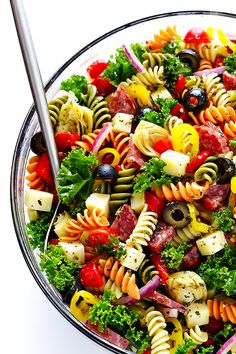 a bowl filled with pasta, meat and veggies