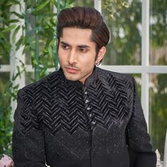 "Make an edgy statement with our BLACK SILVER EMBROIDERED INDO WESTERN designed thoughtfully for the modern Indian man. A fusion staple fit for every occasion, adds the right amount of cultural twist to the western silhouette. Color: Black  Garment Type: Indo Western Neck: Mandarin Collar Fabric: Micro Velvet Embroidery: Zari work with sequin embroidery The Product Price is inclusive of: 1 Indo-Western and 1 Trouser Style Bottom Model is 6'2\" wearing Size 38 Product color may slightly vary due to photographic lighting sources or your screen settings." Designer Ceremonial Sets For Winter, Festive Winter Unstitched Suit With Dabka, Winter Bandhgala With Resham Embroidery For Designer Wear, Fitted Dabka Bandhgala For Winter, Winter Designer Resham Embroidery Bandhgala, Fitted Bandhgala With Dabka Detailing For Winter, Fitted Winter Bandhgala With Dabka Detailing, Designer Ceremonial Sherwani With Mirror Work, Traditional Bandhgala For Winter Groom