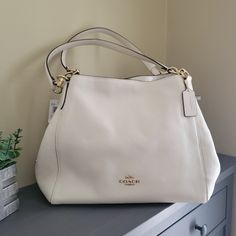 Nwt Coach Hallie Shoulder Bag Refined Pebble Leather Chalk White / Gold New With Tags!!!! Triple Compartment Bag Middle Section Zippered...Magnet Enclosure Refined Pebble Leatherinside Zip, Cell Phone And Multifunction Pockets Center Zip Compartment Snap Closure, Fabric Lininghandles With 8 3/4" Drop12 1/2" (L) X 10 1/2" (H) X 5 3/4" (W) Style No. 80268 Elegant Pebbled Leather Satchel With Handles, Classic Cream Hobo Bag, White Pebbled Leather Top Handle Bag, Cream Textured Leather Satchel Bag, Luxury White Pebbled Leather Bag, White Pebbled Leather Shoulder Bag With Detachable Strap, Pebbled Leather Shoulder Bag For Everyday Use, Everyday Pebbled Leather Bags With Handles, Designer White Hobo Bag For Daily Use