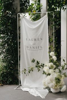 This draped fabric welcome sign is a real classic and chic. Paired perfectly with large vase floral designs in classic white and green tones to match the surrounding venue. Fabric Wedding Sign, Fabric Welcome Sign, Fabric Sign, Wedding Entrance Sign, White Wedding Ceremony, Newcastle Nsw, White Wedding Theme, Personalized Wedding Sign, Wedding Entrance