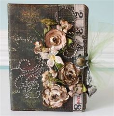 an altered book with flowers on it