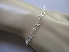 This basic bracelet is made with all soldered heart links chain. The length is adjustable up to 8" with the sterling silver spring ring hooking into any link. The links are 4mm tall and 4.8mm wide.. Heart Chain Bracelet, Basic Bracelet, Heart Chain, Silver Spring, Chain Link Bracelet, Spring Rings, Link Bracelets, Sterling Silver Bracelets, Chain Bracelet