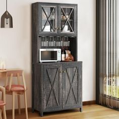 a wooden cabinet with glass doors in a living room next to a table and chairs