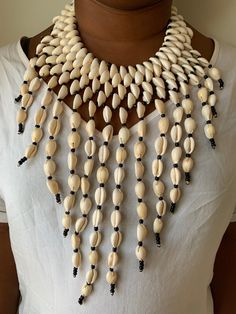 In Africa, the cowrie symbolise destiny and prosperity and in many cases hold significant spiritual and even monetary value. The cowrie shell was an universal form of currency whose relevance weaved into the culture of Ancient African societies. Nubian Queen, African Beads, Cowrie Shell, Choker Necklaces, Necklace Handmade, Collar Necklace, Handmade Necklaces, Tassels, Choker Necklace