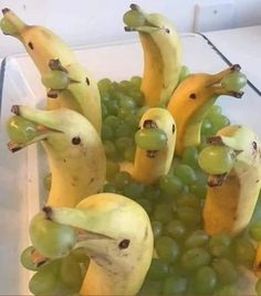 grapes and bananas with faces drawn on them