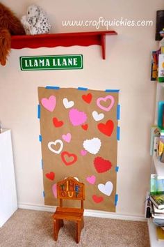 a child's playroom with a chair, book shelf and wall hangings