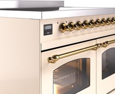 an oven with gold knobs is shown in this image