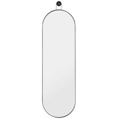 an oval mirror hanging on the wall with a black frame and metal bar at the bottom