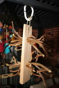 a piece of wood hanging from a hook