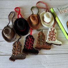 crocheted christmas ornaments are displayed next to a book