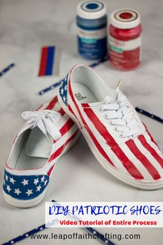 an american flag painted pair of shoes with thread spools on the floor next to them