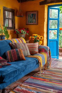 a living room filled with lots of colorful furniture next to a blue door and window