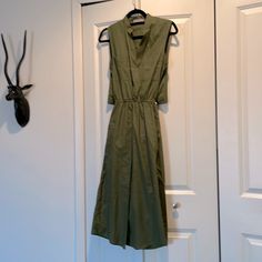 Army Green 100% Cotton .Snap Closure At Chest . 2 Pockets In Front . Elastic Waist Has Strings Can Ties Can Let Hang Or Tie At Back . Cut Out Back At Waist. 2 Front Sides Pockets . New With Tags Pit To Pit “16 Waist “11 Un Stretched Length Shoulders To Hem “45 Olive Sleeveless Midi Dress, Chic Sleeveless Khaki Midi Dress, Khaki Sleeveless Midi Dress For Spring, Khaki Sleeveless Dress For Work, Sleeveless Olive Maxi Dress For Spring, Blue Satin Dress, Grey Shirt Dress, Asymmetrical Midi Dress, Blue Silk Dress