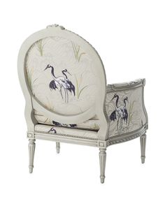 a white chair with two birds painted on it's armrests and back