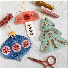 some ornaments are sitting on a table with scissors