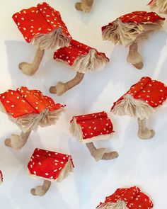 a group of red and white gnomes with polka dots on them