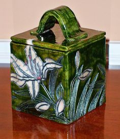 a green box sitting on top of a wooden table