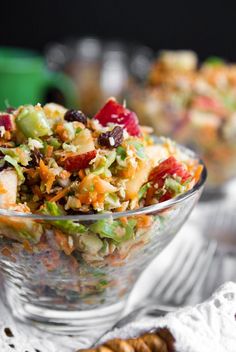 a glass bowl filled with salad and crackers