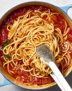 a large pot filled with spaghetti and sauce