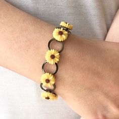 "Such a happy little Sunflower vintage inspired bracelet. This lightweight and comfortable bracelet is easy to wear. It measures 7.5\" in length with 8 little sunflowers firmly glued on flat pads, 9 connecting loops and an easy but sturdy fold over clasp. Your beautiful bracelet will be carefully packaged in a gift box and mailed in a padded envelope with USPS First Class Mail with tracking. Jewelry Care: To keep your handmade jewelry looking lovely protect it from hair spray and perfume as it c Yellow Flower-shaped Retro Jewelry, Retro Yellow Flower Jewelry, Retro Yellow Flower-shaped Jewelry, Retro Yellow Adjustable Bracelets, Vintage Adjustable Hypoallergenic Jewelry, Yellow Vintage Bracelet As Gift, Vintage Friendship Bracelet Jewelry, Vintage Flower Bracelets As Gift, Handmade Vintage Friendship Bracelets