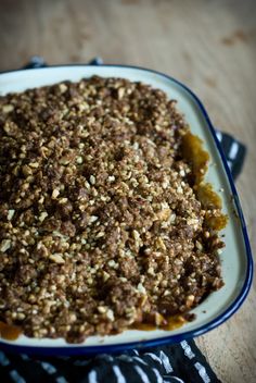 a casserole dish filled with food on top of a wooden table