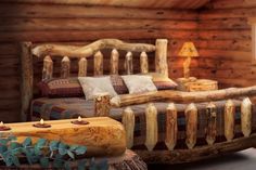 a log bed in a cabin with pillows and blankets