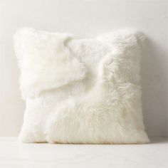 a white fluffy pillow on top of a table