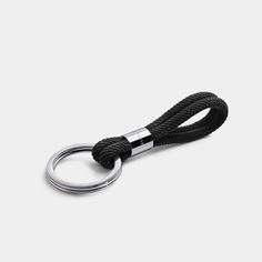 a black rope with a metal ring on it