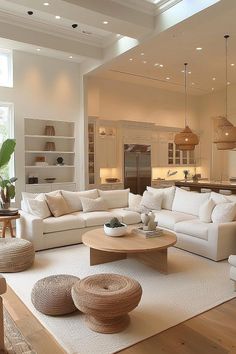 a living room filled with lots of white furniture