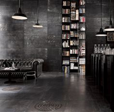 a living room filled with furniture next to a book shelf and bookshelf covered in lots of books