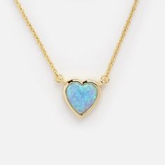 The Lustig Blue Opal Heart Necklace features a shimmering heart shaped simulated opal, bezel set in gleaming gold. This beauty can be worn high, and layered with other necklaces, or slightly longer for a different look! Shop more opal jewelry at Local Eclectic. Valentine's Day Opal Heart Pendant Necklace, Opal Heart Necklace, Melinda Maria Jewelry, Blue Opal Necklace, Local Eclectic, Vermeil Jewelry, Necklace Box, Black Jewelry, Necklace Blue