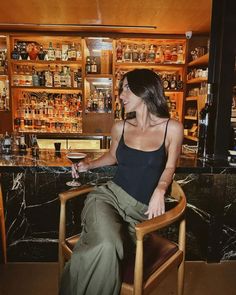 a woman sitting in a chair at a bar